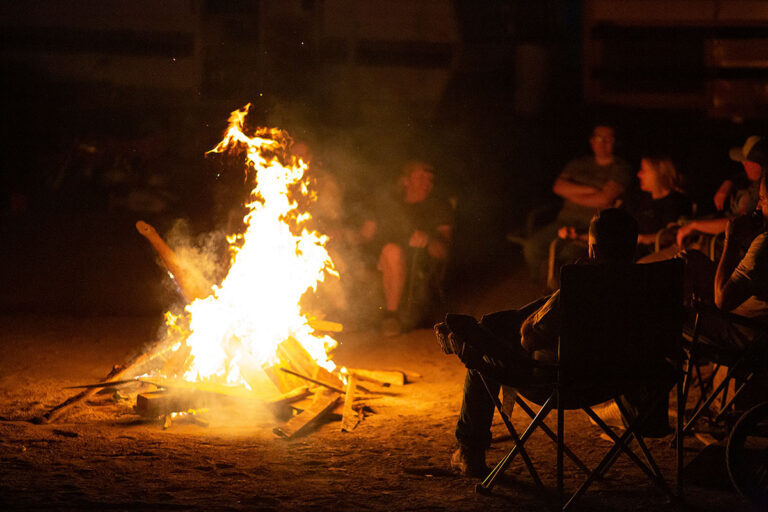people-sitting-around-the-campfire